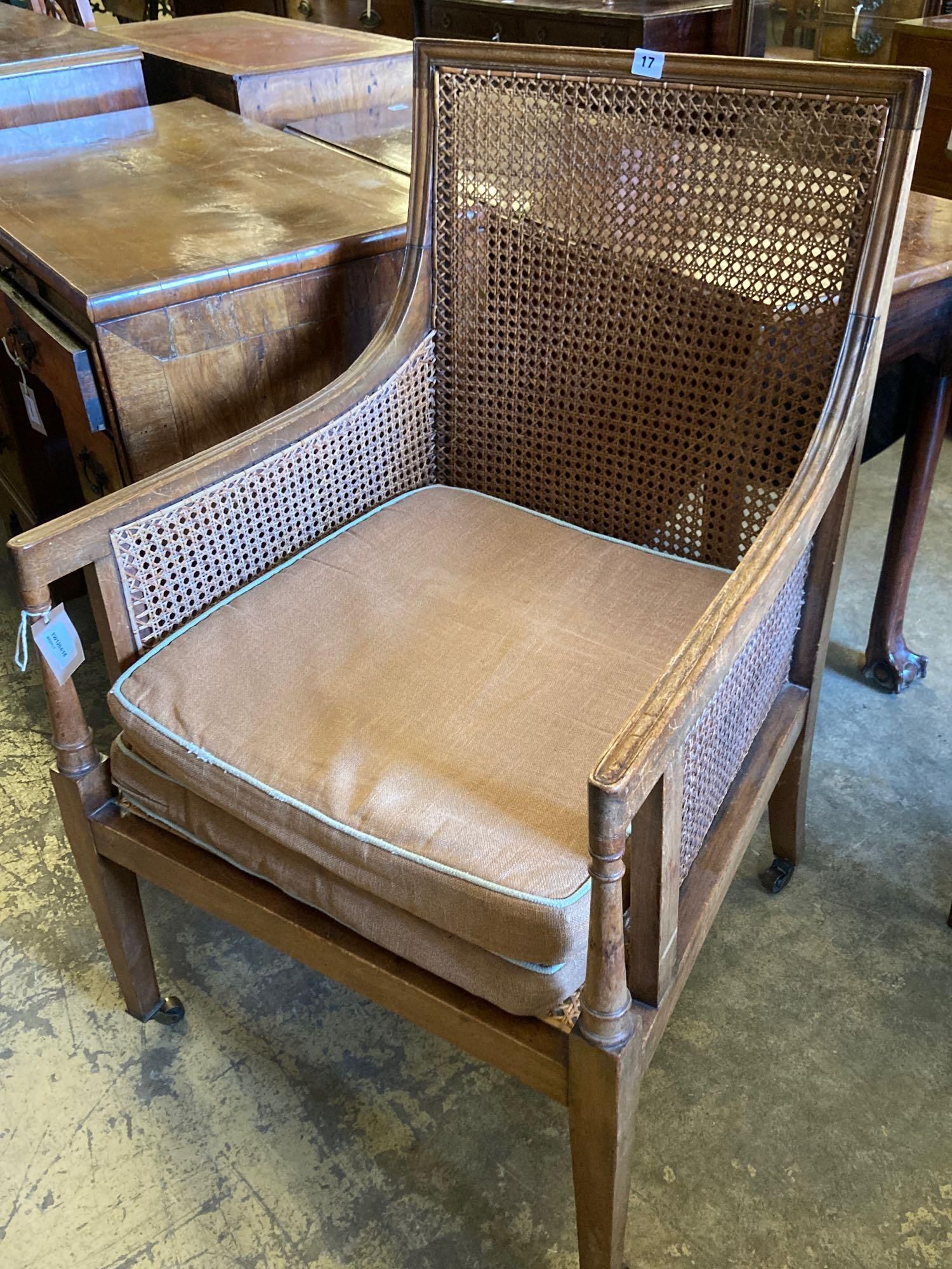 An Edwardian Regency style beech bergere armchair, with caned back and sides, width 60cm